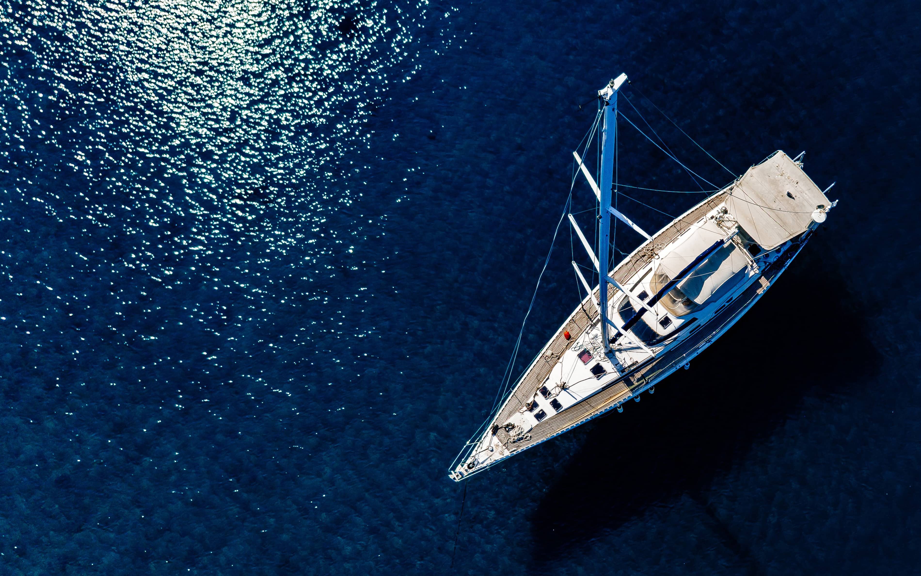 Boat crossing dark blue water near Naoussa
