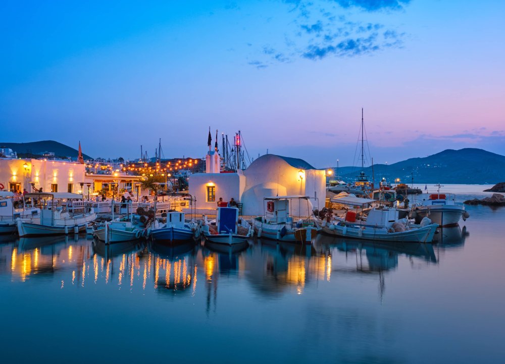 The little Venetian port of Naoussa, Paros, with traditional fishing boats moored along the quay